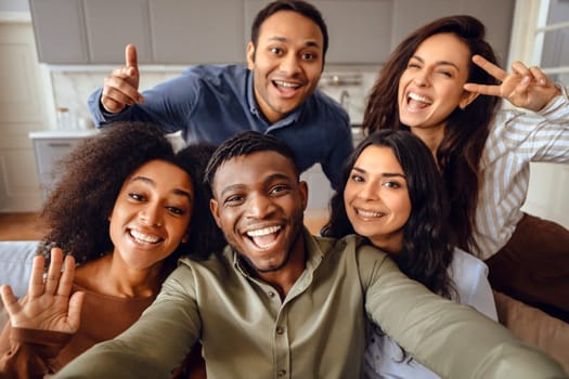 Group of diverse fellow students making selfie posing together indoor