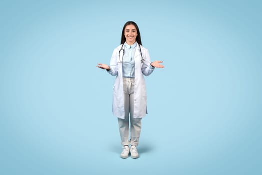 Welcoming female doctor with open hands in lab coat