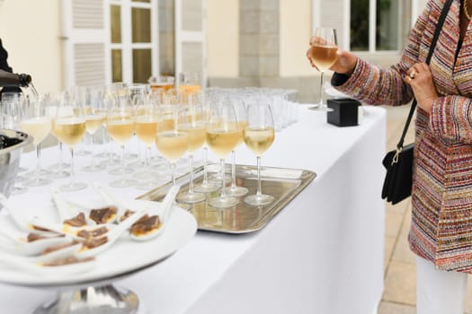 A wedding guest takes champagne and waiters pouring champagne
