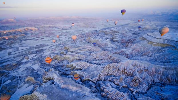 Colorful balloons over volcanic rocks in Cappadocia. Turkey.