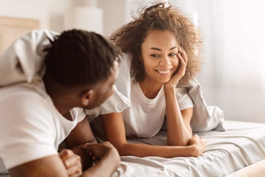 Loving Black Spouses Smiling Enjoying Romantic Morning In Bedroom