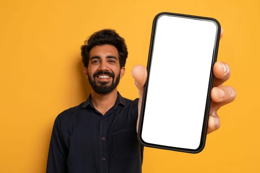 Cheerful Indian Man Showing Big Phone With White Blank Screen