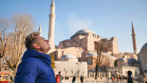Tourist on the background of Hagia Sophia in Istanbul.