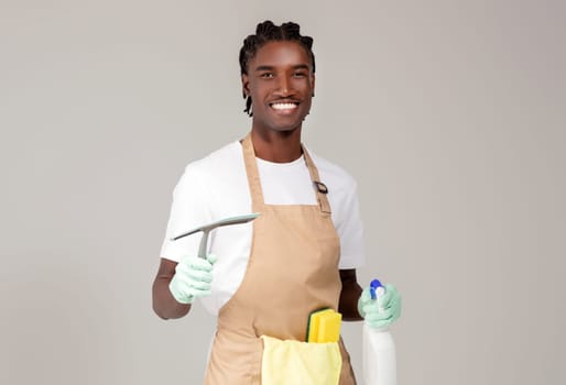 Cleaning Services. Handsome Black Cleaner Man Posing With Detergents And Washing Tools
