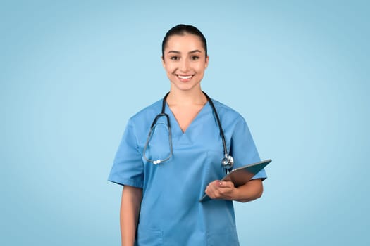 Smiling female doctor with clipboard and stethoscope