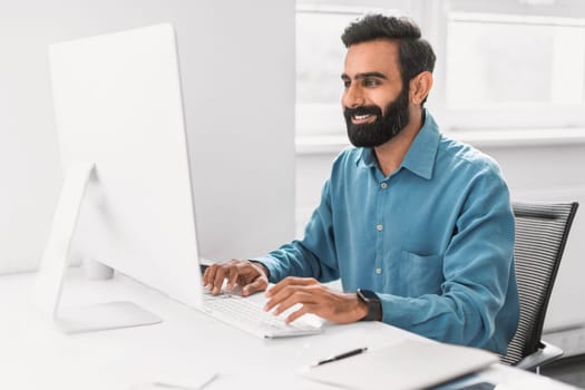 Engaged professional man working on computer in office
