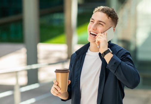 An exuberant young man in a navy blue jacket talking on a smartphone
