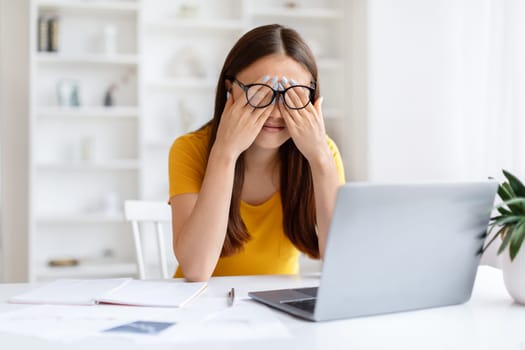 Asian Woman Suffering Eyes Strain While Working With Laptop At Home Office