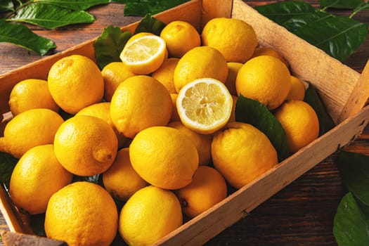 Fresh lemon with leaves in crate