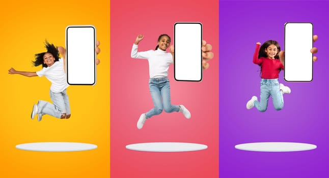 App For Kids. Little Girls With Blank Smartphones Jumping Over Colorful Backgrounds