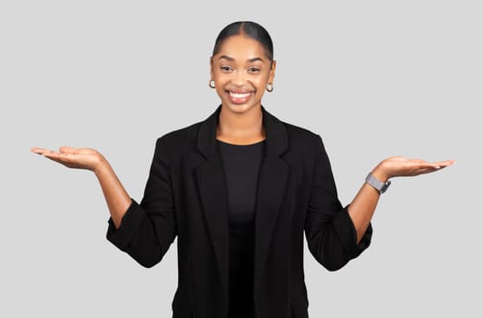Balanced African American businesswoman with open palms facing up