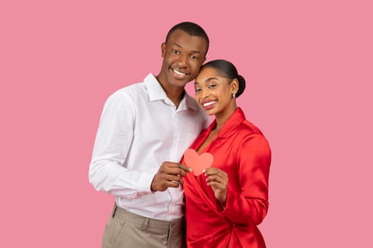 African american couple holding heart, love symbol