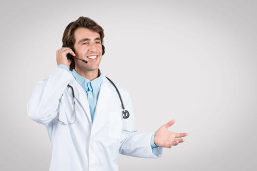 Joyful man doctor with headset talking on the phone