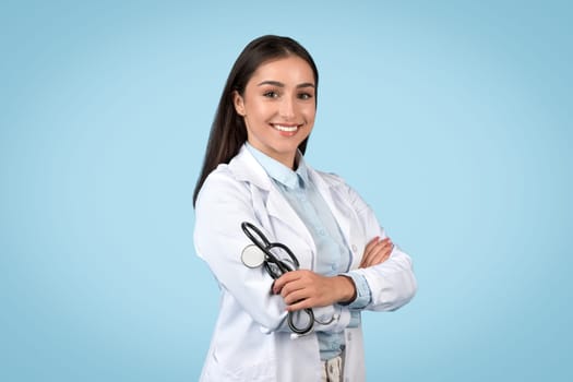 Happy young doctor in lab coat with a stethoscope