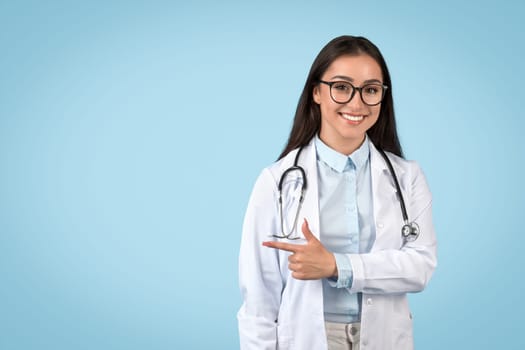 Smiling woman doctor making pointing gesture