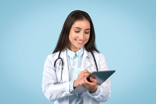 Focused woman doctor using tablet, healthcare technology