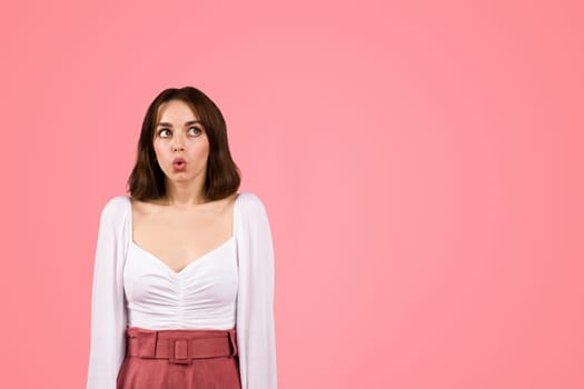 A young woman in a stylish white blouse and burgundy skirt makes a surprised facial expression