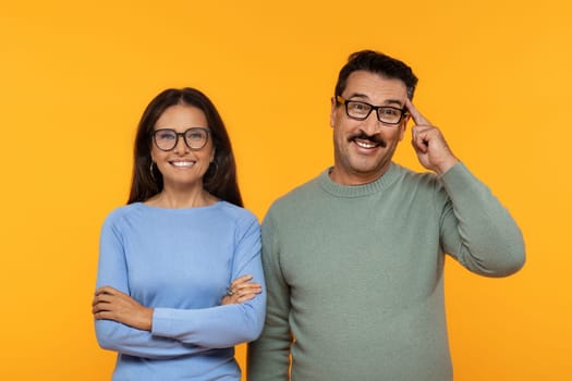 Cheerful caucasian senior family in eyeglasses stand with confidence, woman with arms crossed