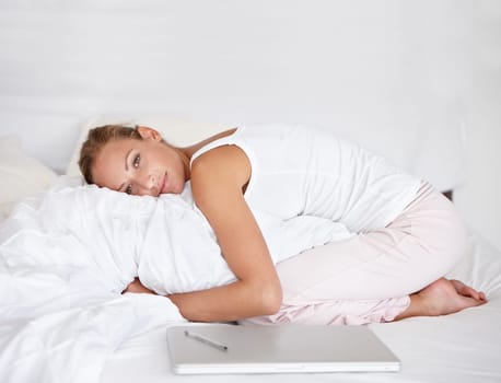 Woman, remote work and relax in portrait on bed with happiness, comfort and pillow. Morning, bedroom and calm person hugging duvet with a smile for nap or rest in apartment with project and laptop