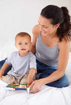 Abacus, portrait and baby with mother playing, learning and education for child development on bed. Bonding, toy and young mom teaching kid, infant or toddler counting for math in bedroom at home.