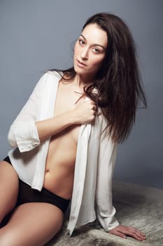 Portrait, underwear and woman in shirt for beauty in studio isolated on a gray background. Body, confidence and fashion of young female model in natural clothes or lingerie on a backdrop in Brazil