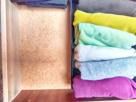 Tidy and organized clothes with the konmari method. Storage of T-shirts folded in a box