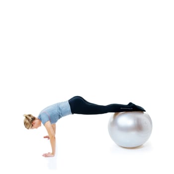 Woman, fitness and push ups with exercise ball for balance training, workout or health and wellness on a white studio background. Female person or athlete on round object for pilates on mockup space