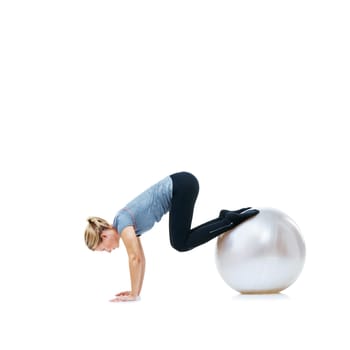 Woman, fitness and exercise on ball for balance, workout or health and wellness on a white studio background. Active female person or athlete on round object in training or pilates on mockup space