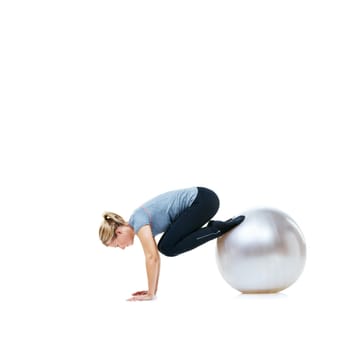 Woman, legs and exercise ball for balance, workout or health and wellness on a white studio background. Active female person or athlete on round object in fitness, training or pilates on mockup space