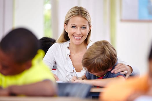 Portrait of happy teacher, kid or writing in classroom for learning, education and helping for development. Woman teaching, boy or child student with knowledge, support or notebook at middle school