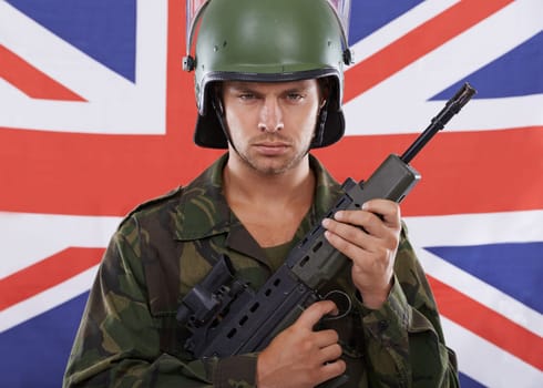 Military, Britain and gun with portrait of man in studio for war, conflict and patriotic. Army, surveillance and security with person and rifle on uk flag for soldier, battlefield or veteran training