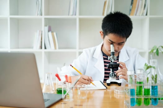 Young Scientist: Elementary Schoolboy Explores with Microscope