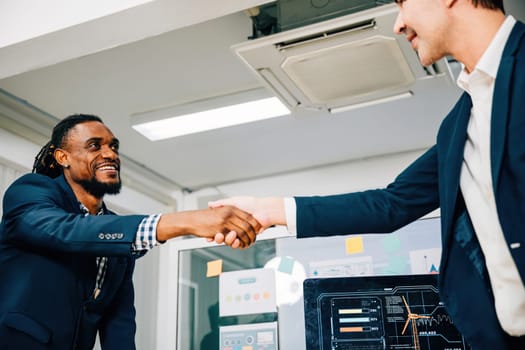 Close-up of a handshake between a young manager and a new employee, symbolizing success and collaboration in their business partnership. Men shake hands during a leadership meeting.