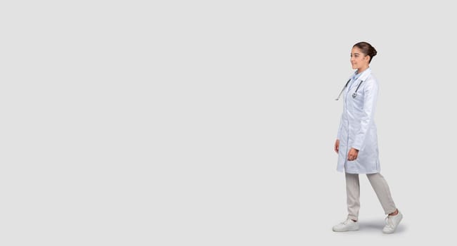 A confident young female doctor in a white lab coat with a stethoscope