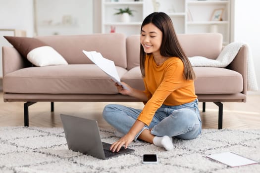 Chinese lady freelancer working from home, using laptop
