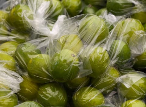 Fresh green lime fruits in plastic bag