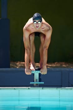 Swimming, sports and man on start block, platform or podium for outdoor fitness exercise, practice or race. Training, athlete and swimmer ready for competition, cardio performance or contest