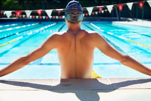 Swimming, water and sports man for pool exercise, outdoor workout or practice for race contest. Aqua, physical activity and back of competitive swimmer ready for waterpolo, fitness or summer cardio