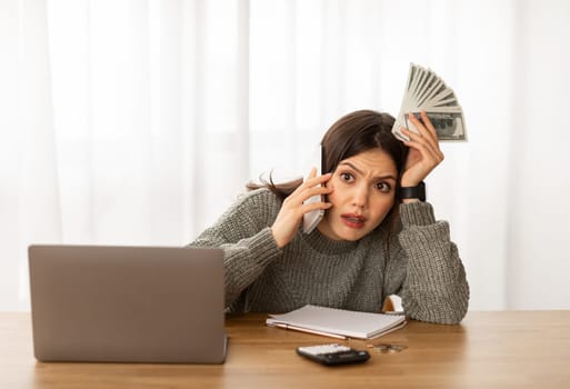 Distressed young woman working on family budget, calling husband