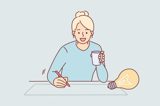 Woman designer draws idea for architectural project on paper, sitting at table with cup of coffee