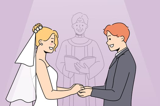 Marriage ceremony of man and woman holding hands, standing near altar with candlestick
