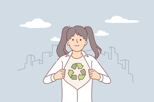Little eco activist girl showing symbol of recycling and environmental sustainability under shirt