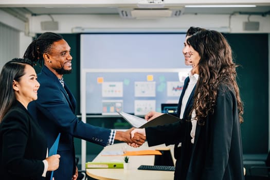 In a meeting, professionals seal a deal with a handshake, demonstrating their successful collaboration and agreement. Executives, lawyers, and managers celebrate their achievement. Teamwork
