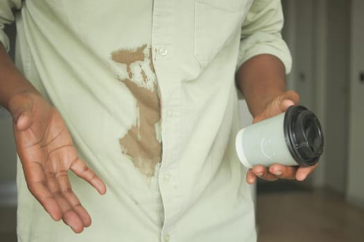 men hands with spilled coffee over his shirt