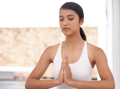 Woman, prayer and meditation for yoga and mindfulness at home, fitness and health with healing and aura balance. Peace, calm and zen with young yogi, meditate for self care and wellness with workout