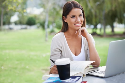 Woman, portrait and coffee with laptop in park, technology and education with textbooks for studying. College student, face or happy in outdoor by tea, books and writing notes by learning on internet