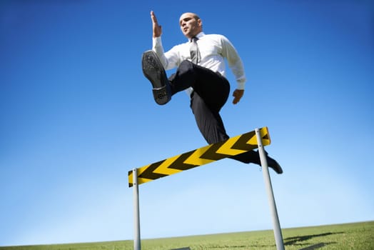 Businessman, hurdle and jumping for career obstacle or competition or employee challenge, growth or achievement. Male person, leap and work professional goals for overcome, job development or mockup