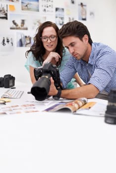 Camera, studio and photographers team editor in an office or workshop for production. Creative, photography and young artists with dslr equipment for editing pictures inspection in modern workplace.