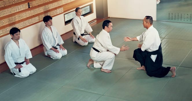 Aikido, class and fight with a master in martial arts with student in self defence, discipline and training. Technique, demonstration or Japanese sensei with black belt skill in fighting or education