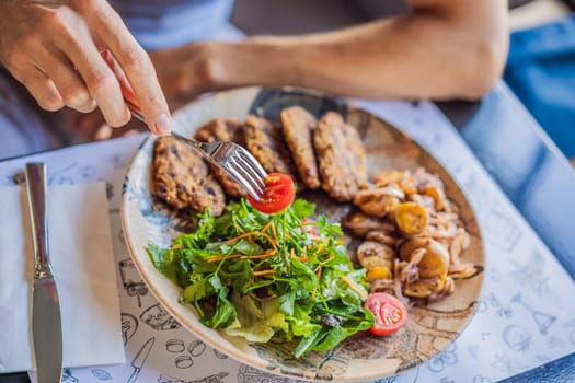Healthy vegan lunch with green salad, vegan cutlets, roasted mushrooms. Vegan, vegetarian meal. Top view, flat lay, above